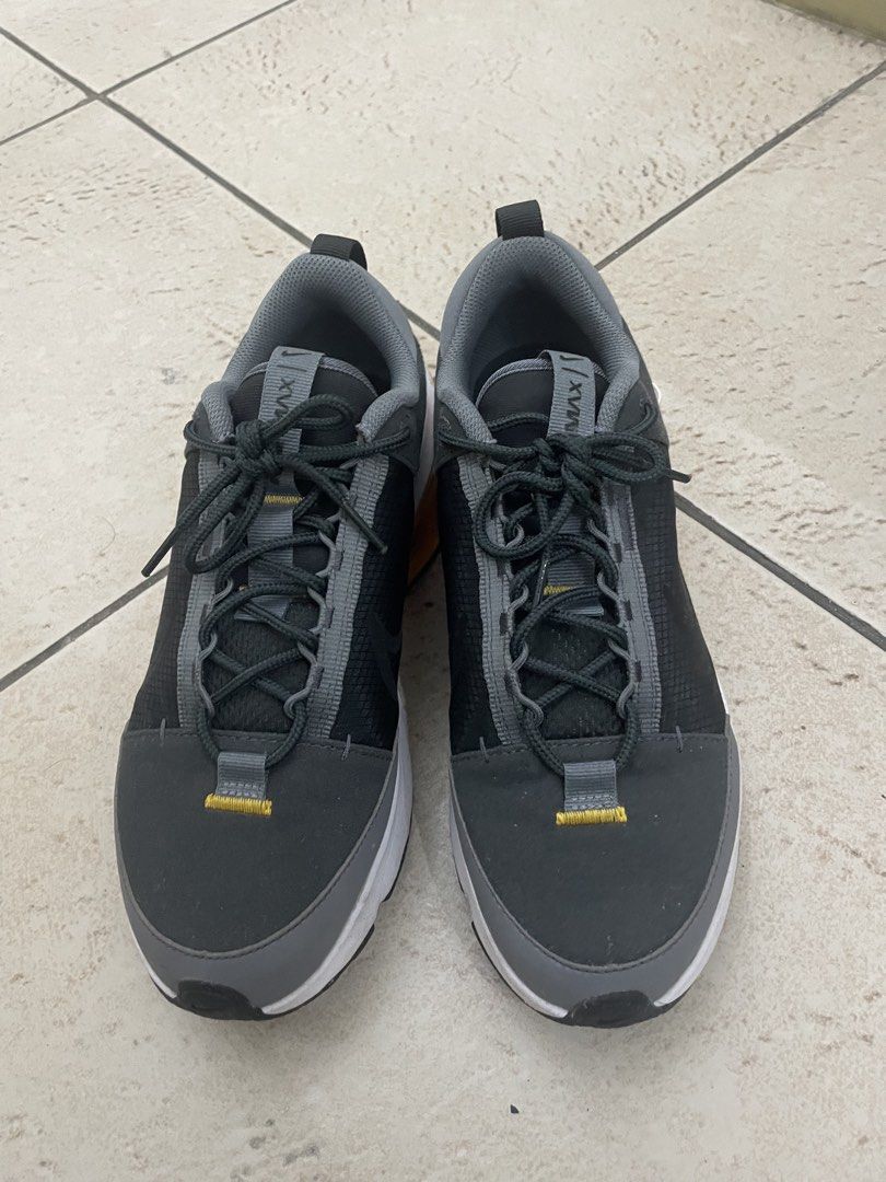 Nike Air Max Alpha Trainer 5 (Category: Sneakers) located in Manila. Submitted by kennethv (Listing ID 1467810057, Image 3). Description: - Brand/Model: Nike Air Max sneakers - Colorway: Grey, black, and white with striking yellow Air Max heel bubbles - Materials: Dark grey mesh upper with durable synthetic overlays and dark laces - Features: Heel pull tabs for easy on and off, standard rubber outsole - Condition: Minor signs of wear on the midso