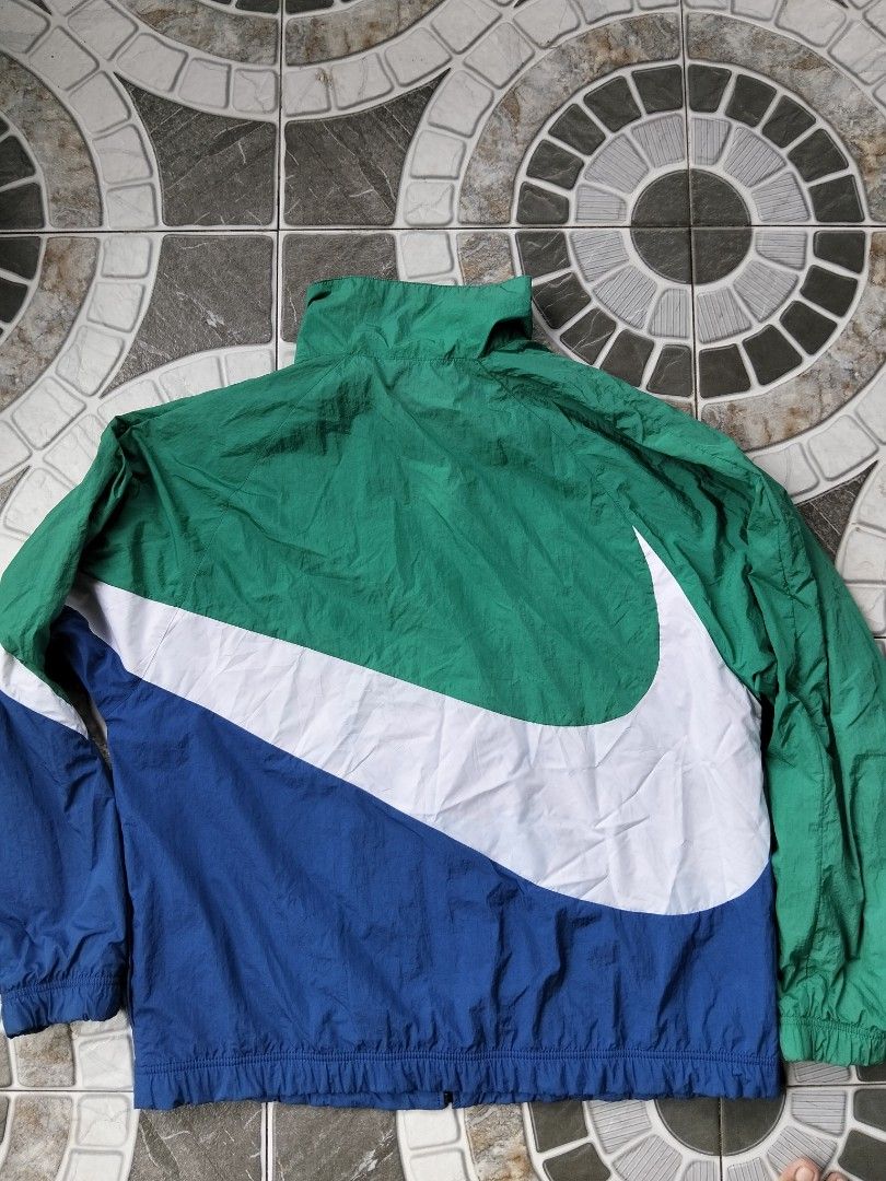 Nike Bigswoosh Windbreaker (Category: Coats, Jackets and Outerwear) located in Nabua. Submitted by tendollardeals (Listing ID 1467619314, Image 2). Description: Nike Bigswoosh Windbreaker Large on tag 24.5x28 Excellent Condition 10-10 color rate Issue:may minimal lang na nahawa na kulay sa check (check last photo).