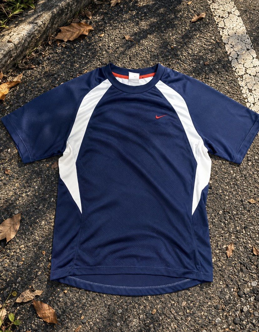 Nike Blue White Athletic T-Shirt (Category: Activewear) located in Caloocan City. Submitted by cleverwater.ba6482 (Listing ID 1467699873, Image 1). Description: - Brand: Nike - Color: Navy blue with white side panels - Logo: Red embroidered swoosh on chest - Design: Short sleeves, crew neck, curved back hem - Material: Lightweight mesh-style fabric - Location: Ships from Philippines - Mode of Payment: GCash, BPI, or COD via supported couriers.