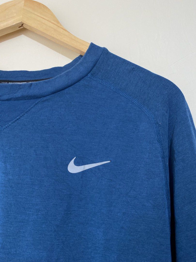 NIKE dri-fit, Long-sleeve sportswear (Category: Activewear) located in Cavite. Submitted by jc_thrift95 (Listing ID 1467775721, Image 3). Description: - a blue Nike long-sleeve athletic or swim top featuring a crew neck and a white/silver Swoosh logo on the chest. - Made in Thailand - Large - L- 29.5 inch - W- 22.5 inch - Color rate 8/10 - See picture details for dimes..