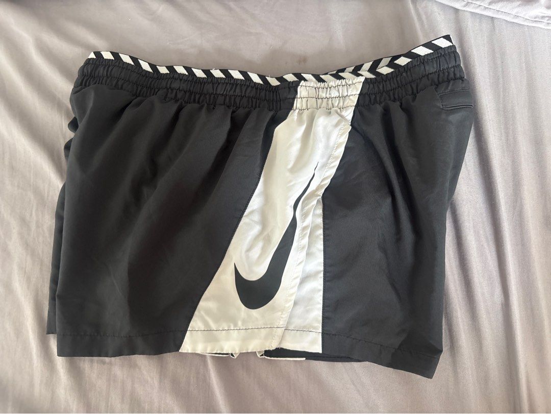 Nike Dri-FIT Running Shorts (Category: Shorts) located in Manila. Submitted by mndoxajc (Listing ID 1467627680, Image 1). Description: - Brand: Nike - Style: Running Shorts - Colorway: Black and White - Size: Large (L) printed inside waistband - Technology: Dri-FIT moisture-wicking - Features: Elasticated striped waistband, branded drawstrings, and a convenient back zipper pocket - Material: Lightweight and breathable, ideal for workouts and acti