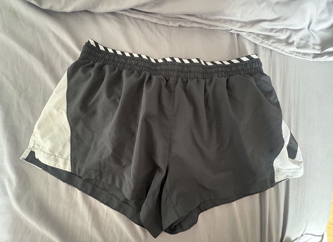 Nike Dri-FIT Running Shorts (Category: Shorts) located in Manila. Submitted by mndoxajc (Listing ID 1467627680, Image 3). Description: - Brand: Nike - Style: Running Shorts - Colorway: Black and White - Size: Large (L) printed inside waistband - Technology: Dri-FIT moisture-wicking - Features: Elasticated striped waistband, branded drawstrings, and a convenient back zipper pocket - Material: Lightweight and breathable, ideal for workouts and acti