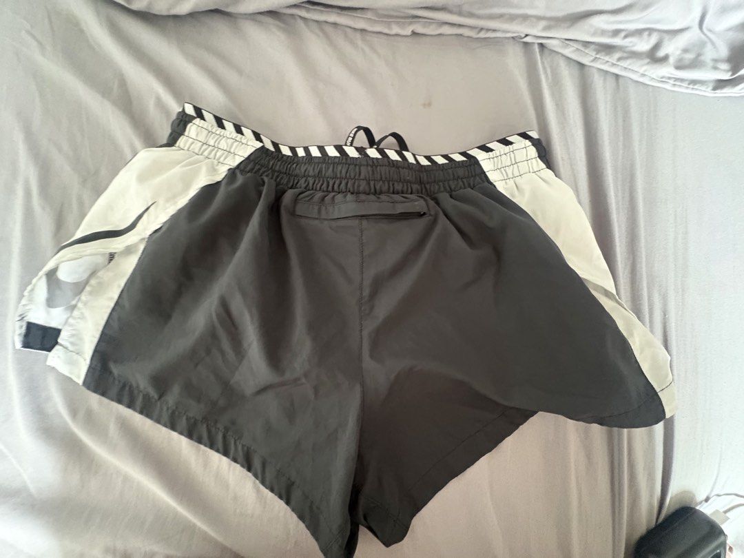 Nike Dri-FIT Running Shorts (Category: Shorts) located in Manila. Submitted by mndoxajc (Listing ID 1467627680, Image 2). Description: - Brand: Nike - Style: Running Shorts - Colorway: Black and White - Size: Large (L) printed inside waistband - Technology: Dri-FIT moisture-wicking - Features: Elasticated striped waistband, branded drawstrings, and a convenient back zipper pocket - Material: Lightweight and breathable, ideal for workouts and acti