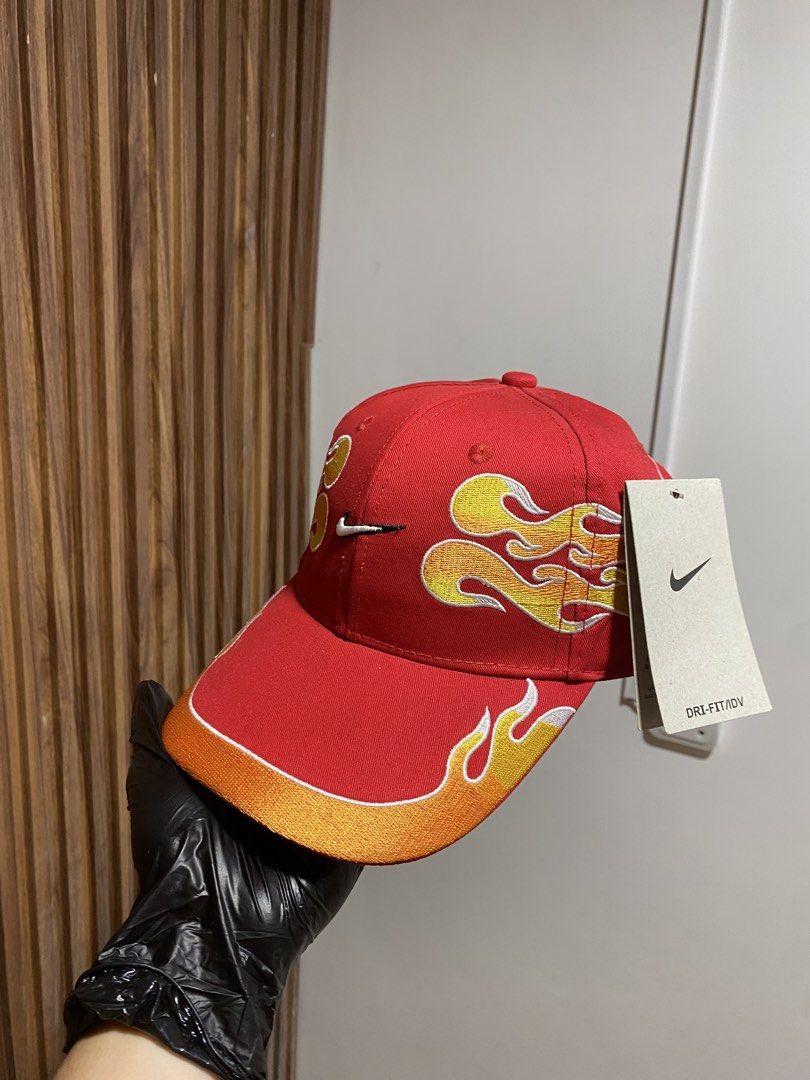 Nike Flame Red Hat Cap with Ferrari Tag (Category: Caps & Hats) located in Caloocan City. Submitted by heatedcaps4425 (Listing ID 1467800479, Image 2). Description: - Brand new with original store tags still attached - Bright red Nike Dri-FIT cap with flame embroidery across the front and sides - Curved brim featuring a stylish orange gradient accent - Rare Ferrari interior tag attached - Adjustable metal strap closure with an embroidered Swoosh 
