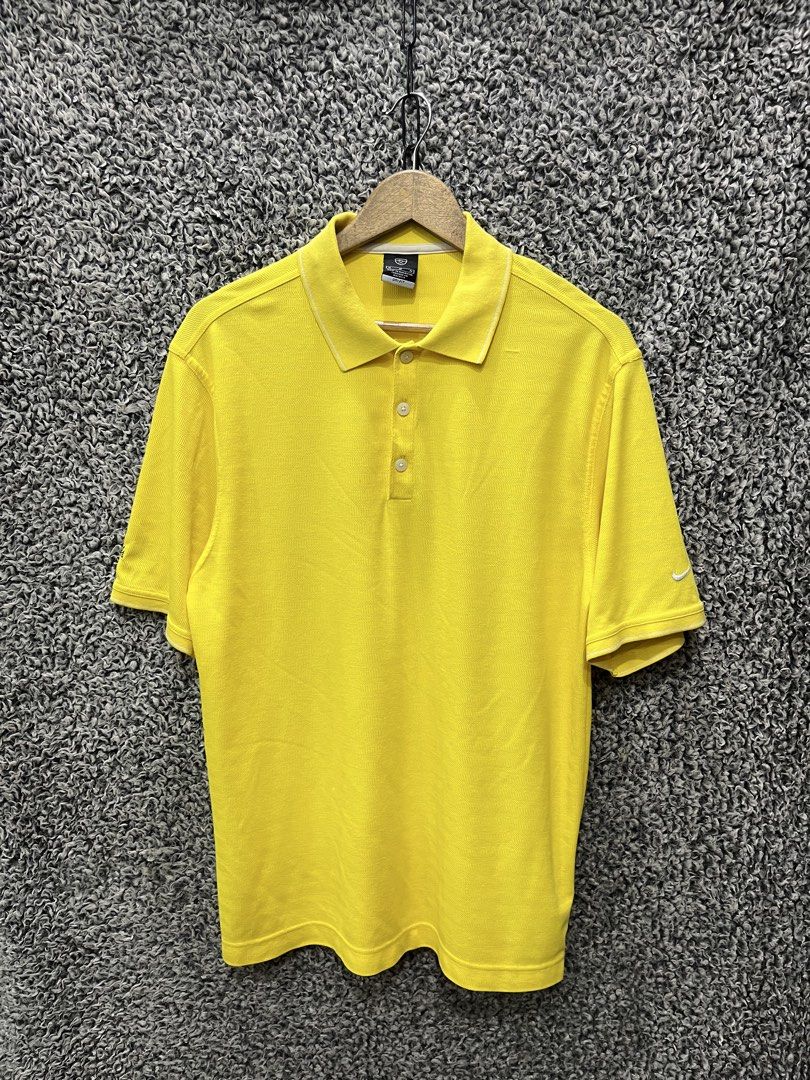 Nike Golf Dri-FIT Polo | Size M (Category: Tshirts & Polo Shirts ) located in General Trias. Submitted by zrchustle.604 (Listing ID 1467827093, Image 1). Description: Nike Golf Dri-FIT Polo Shirt featured in a bright yellow colorway. This specific athletic style features a traditional short-sleeve construction, a three-button placket, subtle piping details along the collar and cuffs, and the classic embroidered Nike Swoosh trademark logo on the s