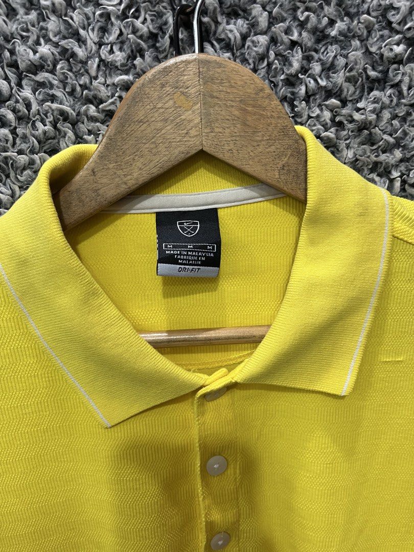 Nike Golf Dri-FIT Polo | Size M (Category: Tshirts & Polo Shirts ) located in General Trias. Submitted by zrchustle.604 (Listing ID 1467827093, Image 3). Description: Nike Golf Dri-FIT Polo Shirt featured in a bright yellow colorway. This specific athletic style features a traditional short-sleeve construction, a three-button placket, subtle piping details along the collar and cuffs, and the classic embroidered Nike Swoosh trademark logo on the s