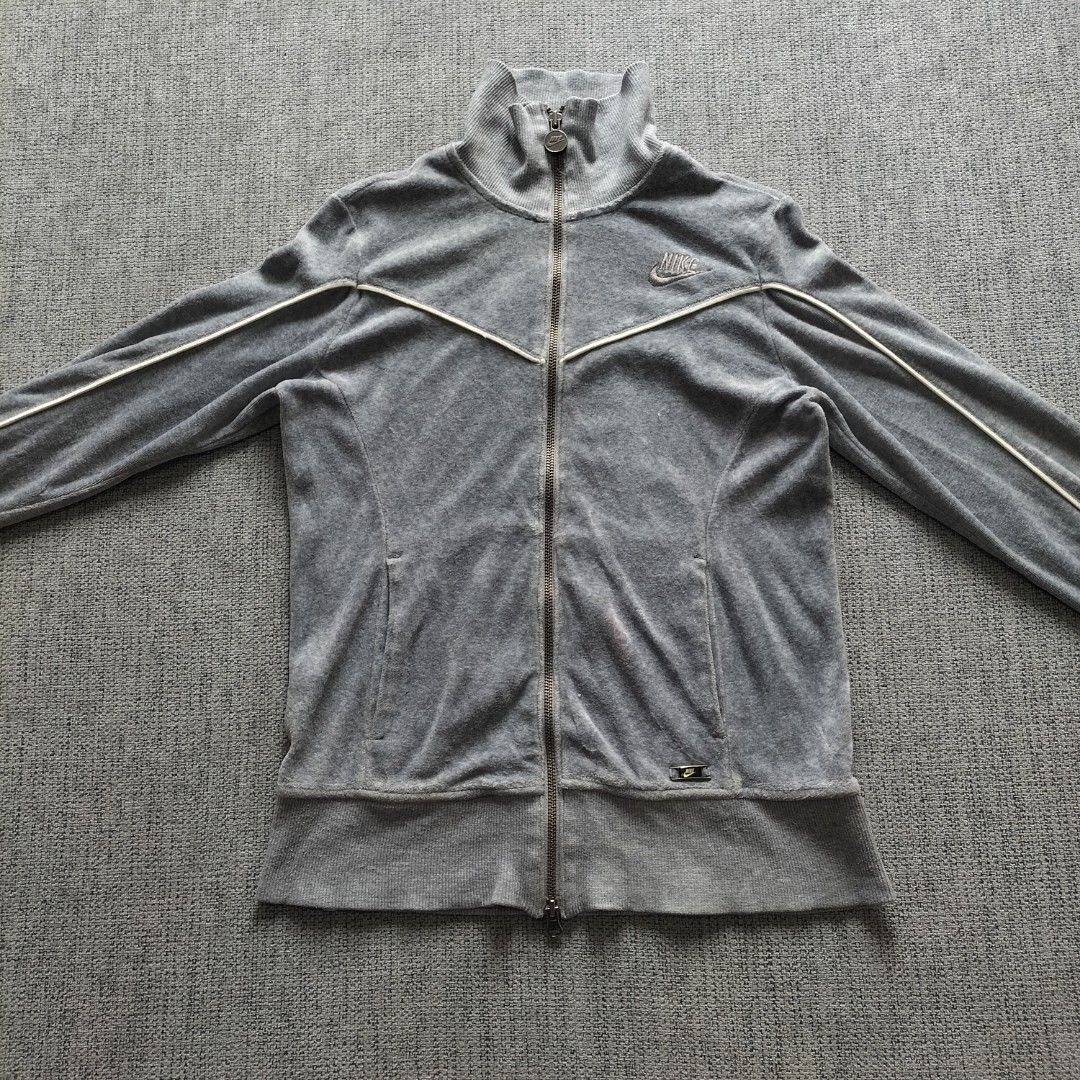 Nike Gray Velour Track Jacket Full Zip YKK (Category: Coats, Jackets and Outerwear) located in Taytay. Submitted by calmtree-6248 (Listing ID 1467637965, Image 1). Description: - Color: Gray with white piping - Material: Premium soft velour - Branding: Embroidered Nike logo on chest & small metal badge near hem - Hardware: YKK main zipper with custom round Nike zipper pull - Features: Ribbed collar, cuffs, and hem, plus two front pockets - Condit
