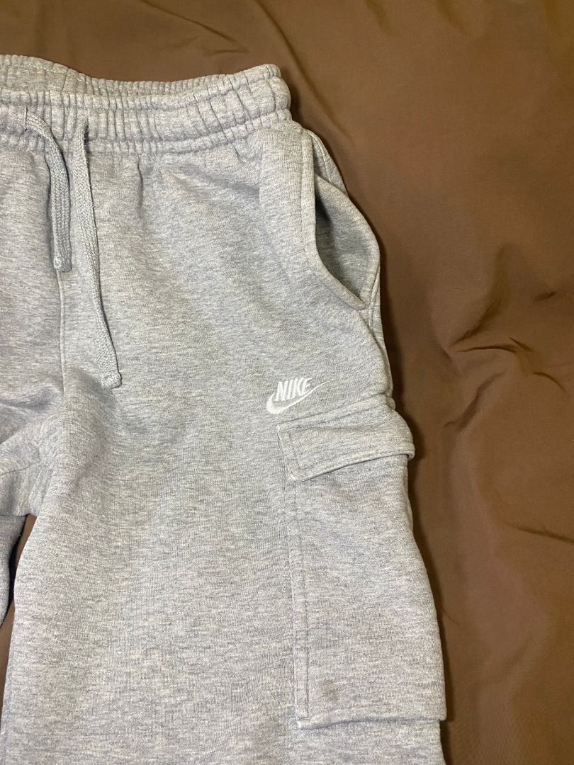 Nike Grey Cargo Sweatpants (Category: Joggers) located in San Pablo. Submitted by kisha_santonia (Listing ID 1467668434, Image 3). Description: - Brand: Nike - Style: Cargo sweatpants with side utility pockets - Color: Grey with embroidered white Nike logo - Size: L (Tag attached) - Measurements: Total length approx. 34 inches, ankle opening approx. 5 inches across - Material: Soft cotton fleece inside for maximum comfort - Features: Drawstring w