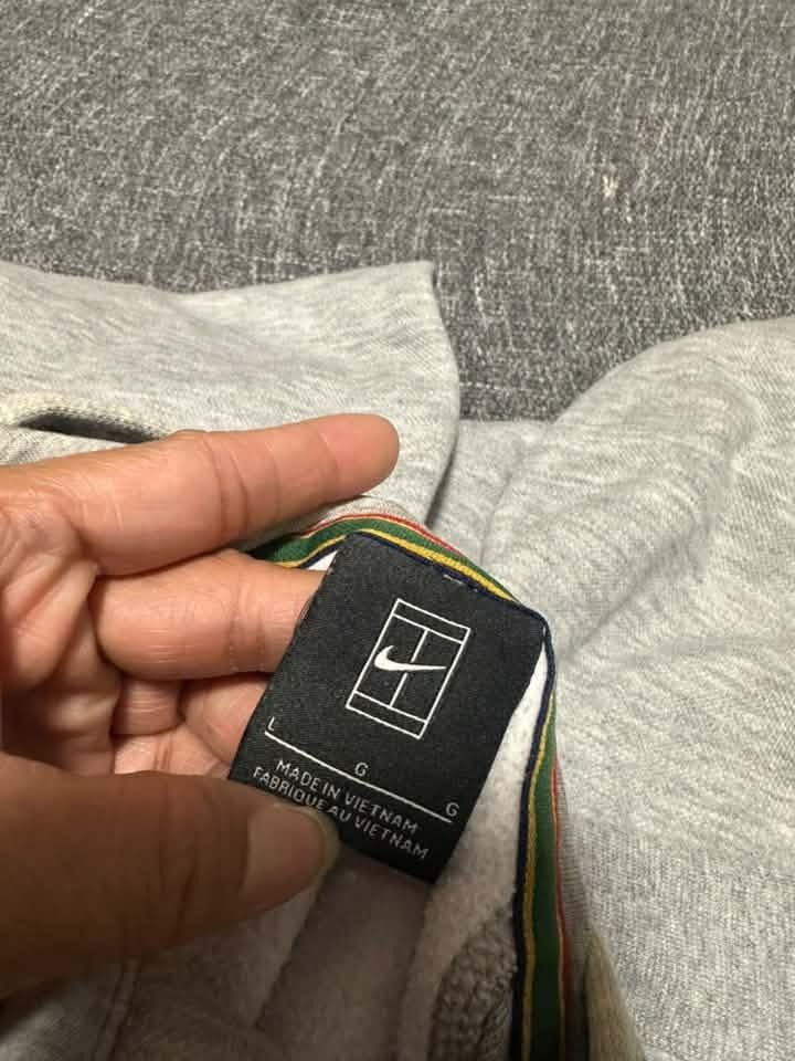 NIKE grey hoodie with a half-zip front, black drawstrings, (Category: Coats, Jackets and Outerwear) located in Manila. Submitted by thriftedbykab (Listing ID 1467711159, Image 2). Description: -Brand: NIKE -Complete tags -Size: (L) -Width: 21 | Length: 25 -Condition: SEMI USED -Color Rate: 8.5/10 -Issue: SEE PICS.