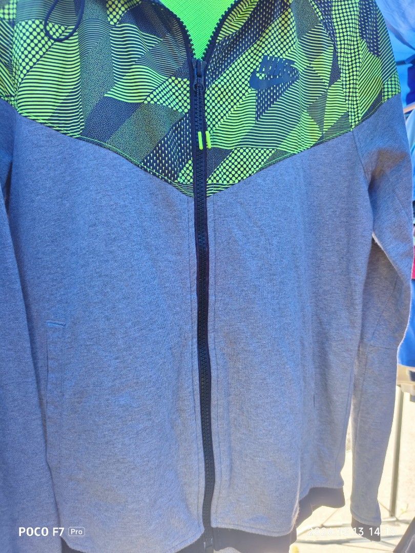 Nike hoodie jacket (Category: Coats, Jackets and Outerwear) located in Mexico. Submitted by josephnuqui1980 (Listing ID 1467654637, Image 2). Description: This is a grey and electric green Nike RU Windrunner Finisher Overlay Hooded Jacket Size Large on tag.
