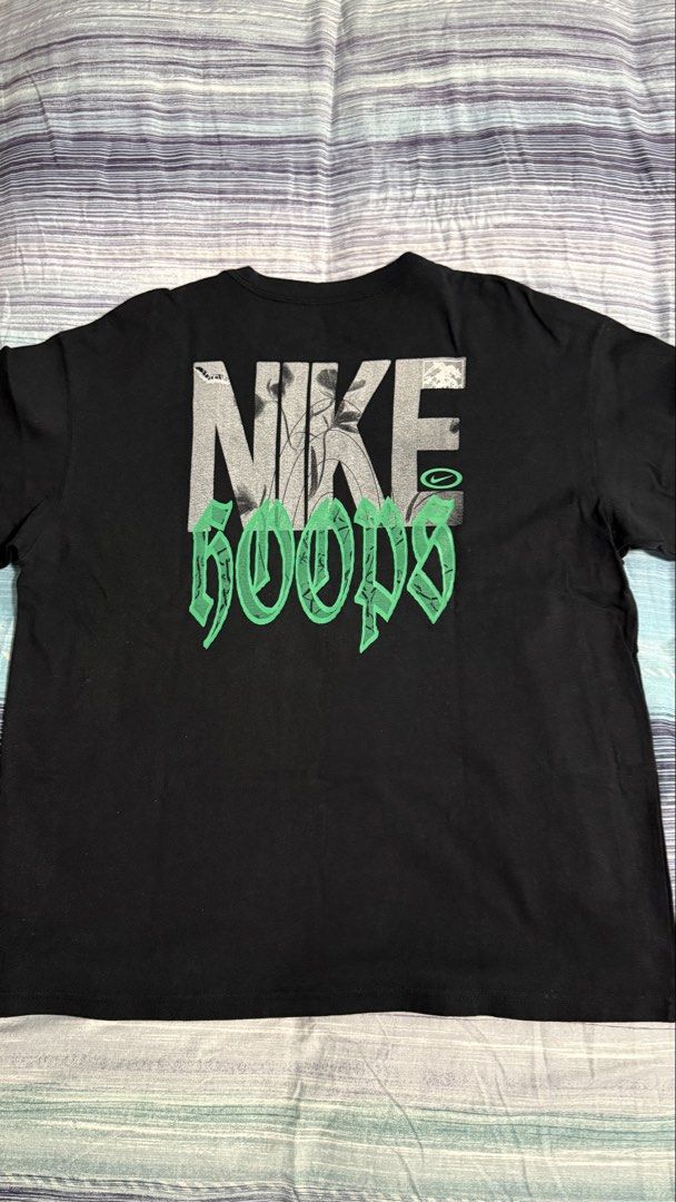 Nike Hoops Black T-Shirt Graphic Tee (Category: Tshirts & Polo Shirts ) located in Quezon City. Submitted by kobeeeee_12 (Listing ID 1467641995, Image 1). Description: - Brand: Nike (The Nike Tee) - Style: Black Hoops graphic t-shirt - Front: Small basketball net graphic on chest - Back: Large grey and green Nike Hoops text logo - Condition: Excellent / Pre-loved - Shipping or meetup options available.