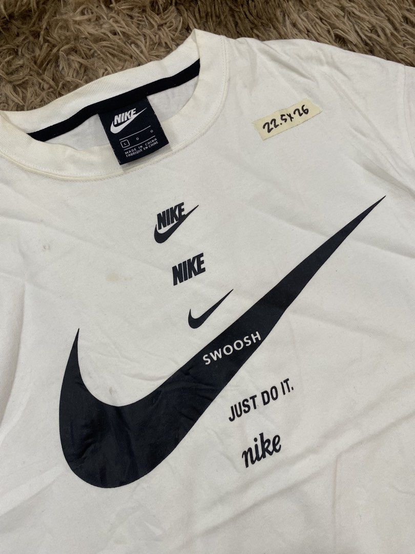 Nike Multi Logo White T-Shirt (Category: Tshirts & Polo Shirts ) located in Cagayan de Oro. Submitted by sepamorash53558 (Listing ID 1467643702, Image 2). Description: - Brand: Nike - Color: White - Material: 100% Cotton - Size: L (Chest 90cm) - Measurements: 22.5" pit-to-pit, 26" length - Design: Stacked logo and swoosh graphic on chest - Fit: Standard fit, casual streetwear - Origin: Made in China.