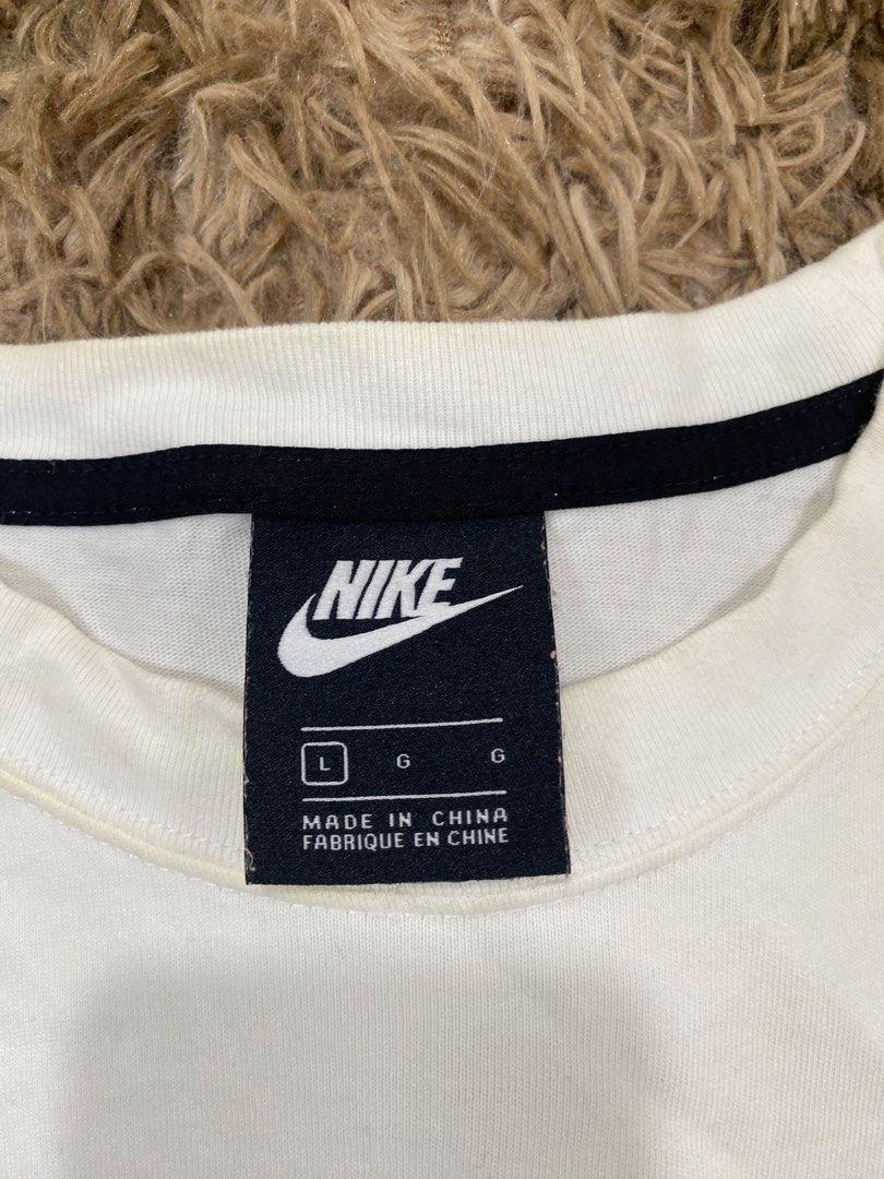 Nike Multi Logo White T-Shirt (Category: Tshirts & Polo Shirts ) located in Cagayan de Oro. Submitted by sepamorash53558 (Listing ID 1467643702, Image 3). Description: - Brand: Nike - Color: White - Material: 100% Cotton - Size: L (Chest 90cm) - Measurements: 22.5" pit-to-pit, 26" length - Design: Stacked logo and swoosh graphic on chest - Fit: Standard fit, casual streetwear - Origin: Made in China.