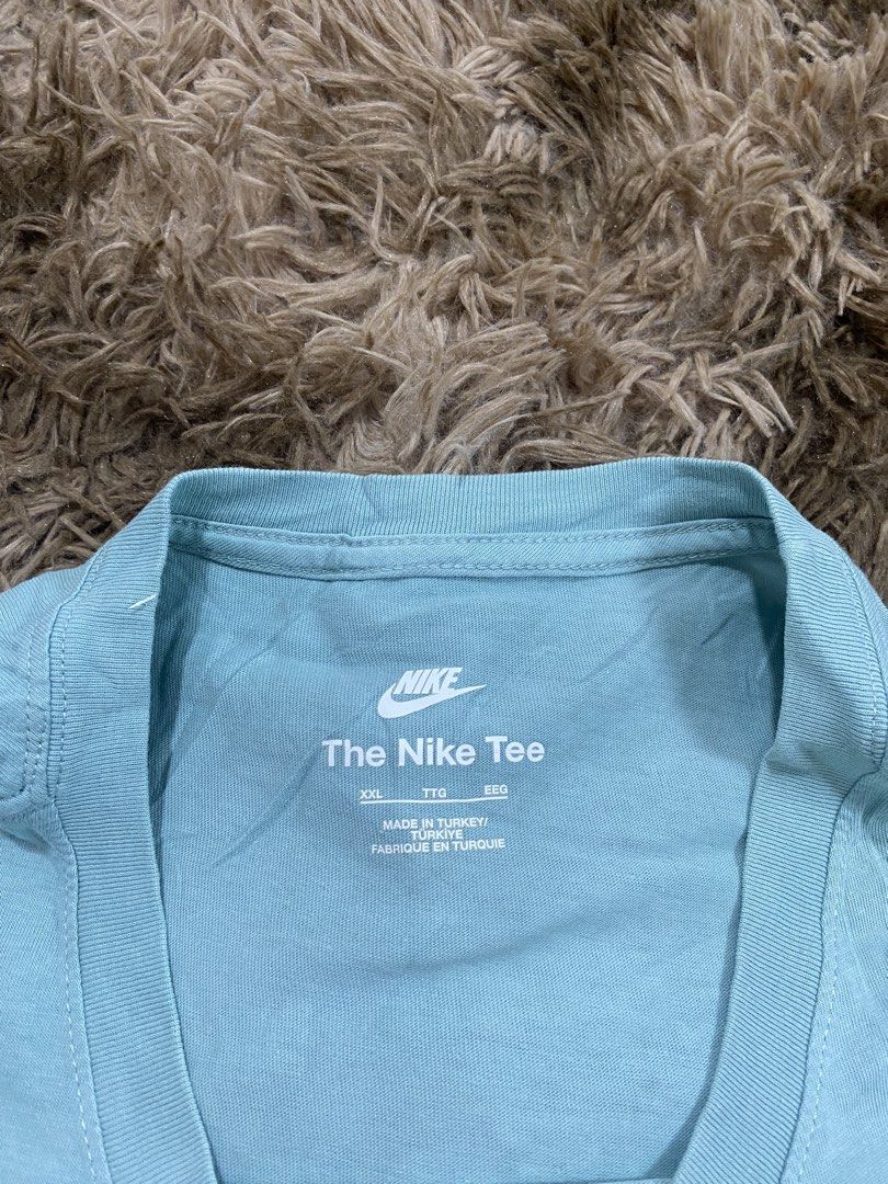 Nike The Nike Tee Light Blue XXL (Category: Tshirts & Polo Shirts ) located in Cagayan de Oro. Submitted by sepamorash53558 (Listing ID 1467642885, Image 3). Description: - Brand: Nike (The Nike Tee) - Size: XXL (Tag: 110cm chest) - Color: Light blue - Material: 100% cotton (Made in Turkey) - Design: Classic embroidered swoosh logo on the chest - Style: Crew neck, soft material - Flat Lay Measurements: 22 inches (width) x 29 inches (length).