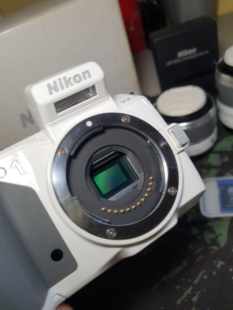 Nikon 1 V2 Mirrorless Camera Twin Lens Kit (Category: Cameras) located in Manila. Submitted by zeyon360 (Listing ID 1467755782, Image 2). Description: 📷Selling my beloved Nikon V2 for 16k. Perfect for street photography & travels. Produces sharp images (check uploaded photos at the end). No issues, no fungus Complete with box, manual, accessories Still in mint condition. No vignette, clean sensor, flash working. Seldomly used Fast AF, shoots vid