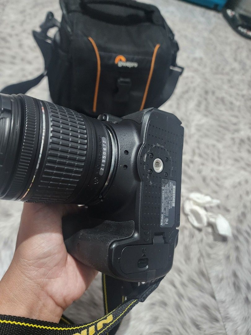 Nikon D5300 Camera with Lens and Lowepro Bag (Category: Cameras) located in Valenzuela. Submitted by sunshinebucud (Listing ID 1467660749, Image 2). Description: - Nikon DSLR camera body and zoom lens ready for shooting - Includes Nikon neck strap and padded Lowepro shoulder bag - Fully functional setup with clean optics and responsive buttons - Battery door is completely intact - Minor cosmetic scuffs around the bottom tripod mount plate.