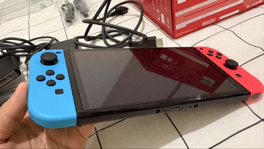 Nintendo Switch OLED (Neon) - Complete Box + Case & Screen Protector (Bought May 2026) (Category: Nintendo) located in Calamba. Submitted by josephsalv38175 (Listing ID 1467723933, Image 3). Description: Selling my barely used Nintendo Switch OLED unit. Purchased last May 2026 from GameXtreme Official Store (TikTok Shop). Pristine console condition, complete with protection and accessories! PRICE: ₱11,500 (Slightly negotiable for quick/sure buyer