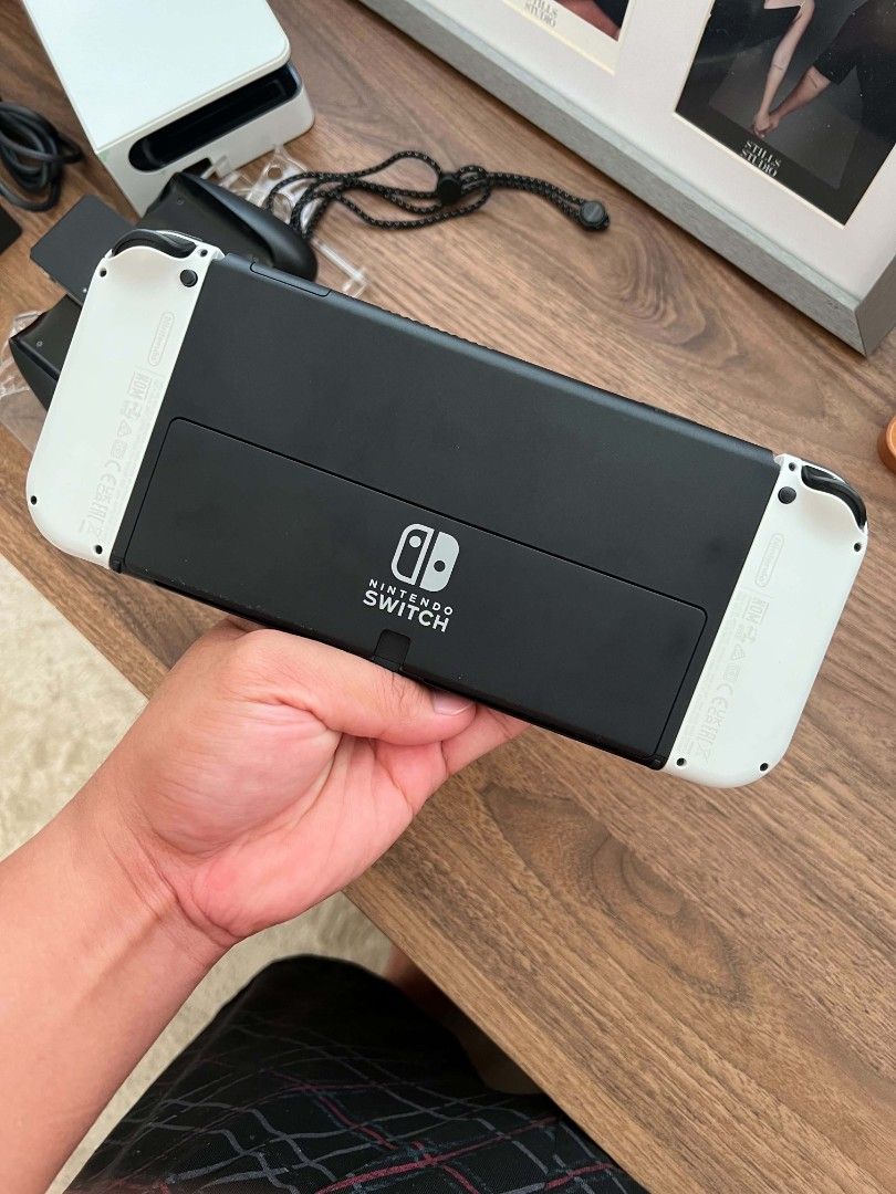 Nintendo Switch OLED White Console Full Bundle (Category: Nintendo) located in Cavite. Submitted by pitchblack012 (Listing ID 1467613943, Image 3). Description: - Nintendo Switch OLED Console (White) - 100% working condition, zero issues - Complete with original docking station, power adapter, and HDMI cable - Includes White Joy-Con controllers with grip attachments and wrist straps - Pre-installed cute cat paw thumb grips for extra comfort and s