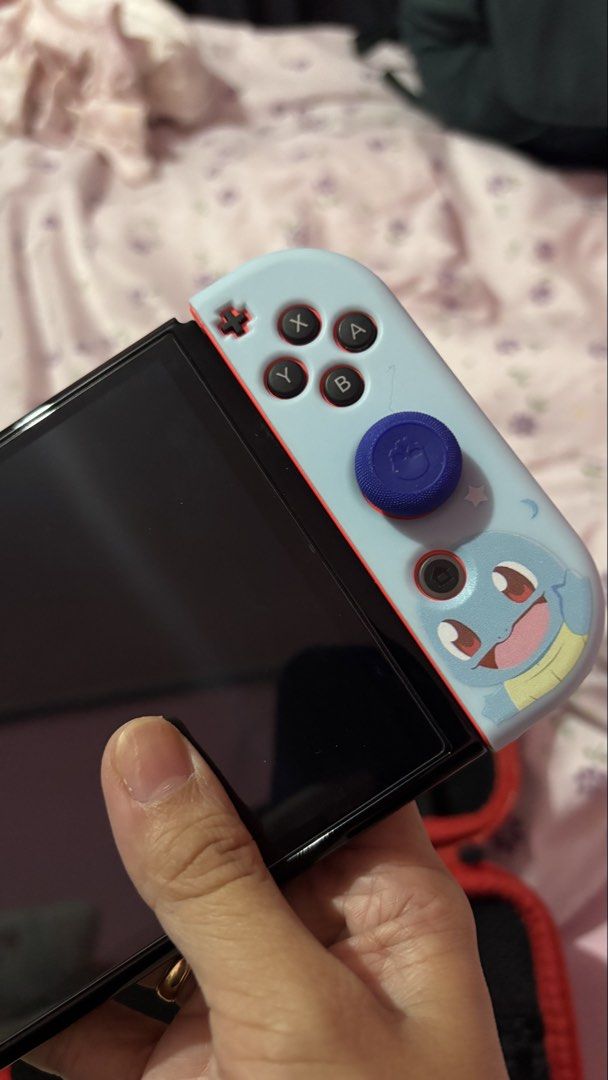 Nintendo Switch OLED with Pokemon Squirtle Grips (Category: Nintendo) located in Quezon City. Submitted by aistar (Listing ID 1467731557, Image 2). Description: 🎮 FOR SALE: Nintendo Switch OLED + Physical Zelda Game 🎮 Selling my Nintendo Switch OLED in excellent condition. Barely used and well taken care of. Perfect for anyone looking for a Nintendo Switch at a great price 💖 ✨ Inclusions: * Nintendo Switch OLED unit * Original Nintendo dock * 