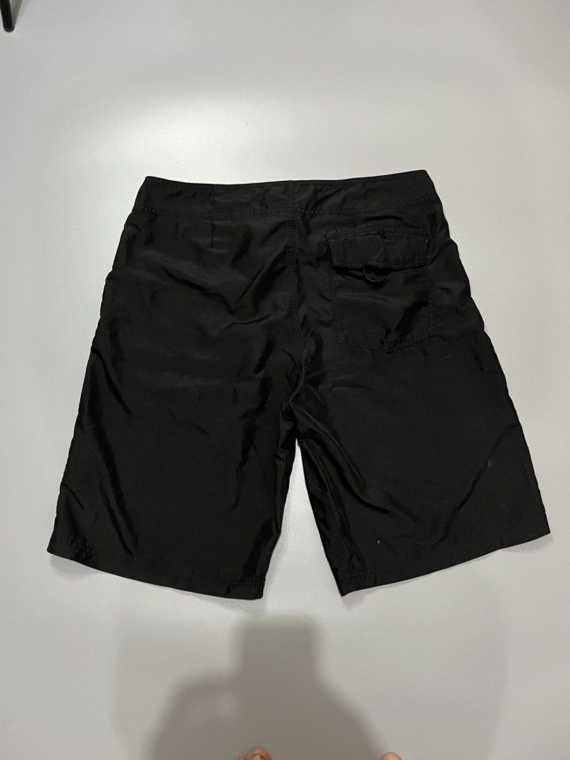 Oakley Black Board Shorts Size 32 (Category: Swim Trunks & Board Shorts) located in Manila. Submitted by jorgemabelin2001 (Listing ID 1467759891, Image 2). Description: - Brand: Oakley - Size: 32 - Color: Solid black - Waist: Adjustable drawstring with branded aglets - Storage: Back pocket featuring a built-in key loop - Details: Subtle embroidered ellipse logo on the lower leg - Authenticity: Interior waist tag displaying size and manufacturing 