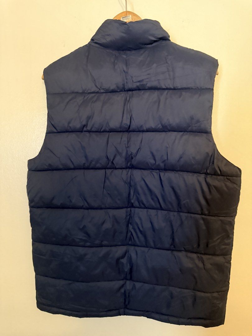 Old Navy Puffer Vest Navy Blue Size M (Category: Vests) located in Manila. Submitted by amdra25 (Listing ID 1467639248, Image 2). Description: - Brand/Model: Old Navy Puffer Vest - Color: Dark navy blue with contrasting rich brown interior lining - Size: Medium (from collar tag) - Design: Quilted construction with full front zipper and stand-up collar - Pockets: Two practical side pockets near the hem - Condition/Usage: Great layering piece for c
