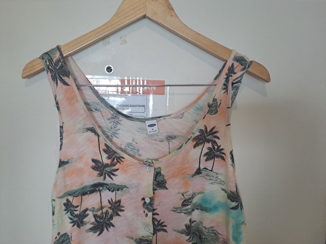 Old navy sleeveless beach top (Category: Sleeveless) located in Manila. Submitted by joanbalde39643 (Listing ID 1467659299, Image 2). Description: This item is an Old Navy Slub-Knit Button-Front Sleeveless Top. It features a tropical watercolor tie-dye pattern adorned with palm tree silhouettes, scoop neck design, and a full button-down front closures..