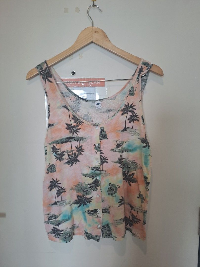 Old navy sleeveless beach top (Category: Sleeveless) located in Manila. Submitted by joanbalde39643 (Listing ID 1467659299, Image 1). Description: This item is an Old Navy Slub-Knit Button-Front Sleeveless Top. It features a tropical watercolor tie-dye pattern adorned with palm tree silhouettes, scoop neck design, and a full button-down front closures..