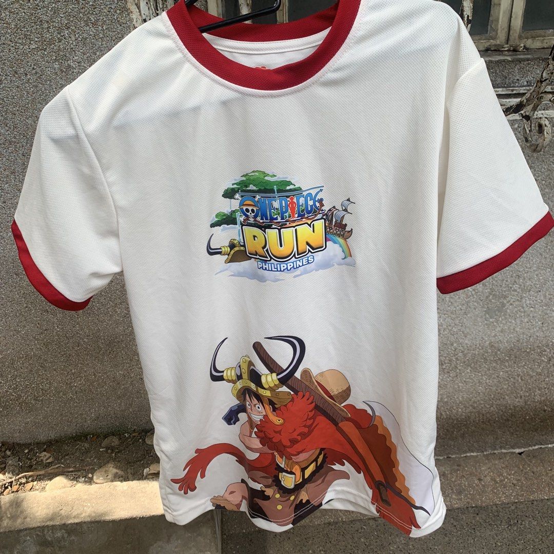 One Piece Run Philippines White Ringer T-Shirt (Category: Shirts) located in Caloocan City. Submitted by diannecarl32964 (Listing ID 1467619866, Image 2). Description: - Color: White with red trim on collar and sleeves - Design: Large One Piece Run Philippines & Luffy graphics on front, Straw Hat crew graphic on back - Material: Lightweight, breathable mesh-style fabric - Fit: Short sleeves, casual style - Condition: Brand new / Excellent quality