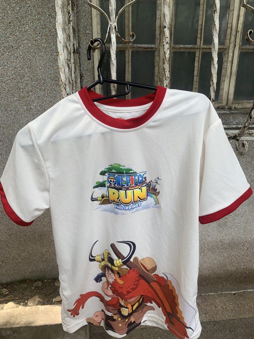 One Piece Run Philippines White Ringer T-Shirt (Category: Shirts) located in Caloocan City. Submitted by diannecarl32964 (Listing ID 1467619866, Image 3). Description: - Color: White with red trim on collar and sleeves - Design: Large One Piece Run Philippines & Luffy graphics on front, Straw Hat crew graphic on back - Material: Lightweight, breathable mesh-style fabric - Fit: Short sleeves, casual style - Condition: Brand new / Excellent quality
