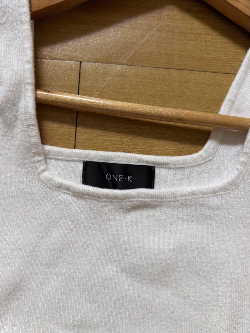 ONE-K White Square Neck Ribbed Tank Top (Category: Sleeveless) located in Las Pinas. Submitted by ann.co. (Listing ID 1467681893, Image 2). Description: - Brand: ONE-K - Color: Classic White - Style: Square neckline, sleeveless basic - Material: Soft and stretchable knit - Condition: Clean overall - Versatility: Great for layering or wearing on its own.
