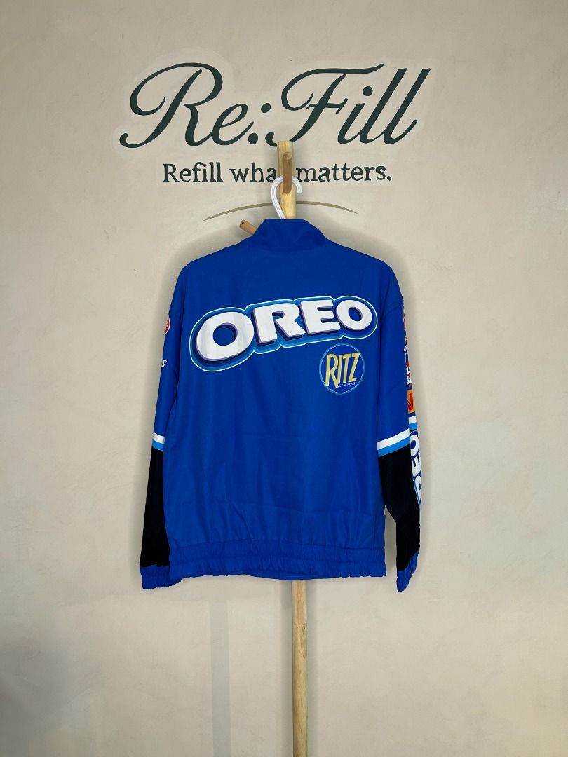 OREO NASCAR Racing Promotional Jacket (Category: Coats, Jackets and Outerwear) located in Taguig. Submitted by re.wear.mnl (Listing ID 1467702080, Image 2). Description: - Bold blue racing jacket with eye-catching OREO logo across the front and back - Features iconic sponsor patches including Ritz, Post, Fig Newtons, Nutter Butter, and Chevrolet - Secure zip-up front closure with convenient snap buttons at the collar and hem - Stylish black and w