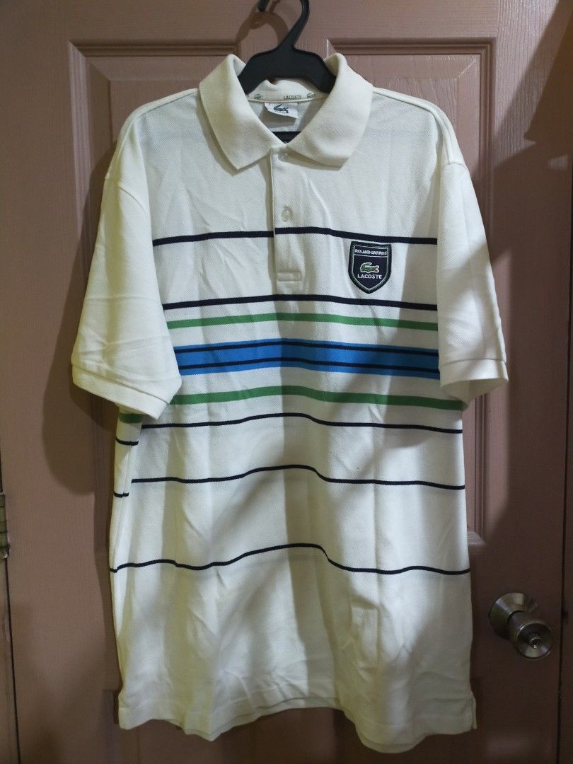 Original Lacoste (Category: Tshirts & Polo Shirts ) located in Quezon City. Submitted by leejong720610 (Listing ID 1467684497, Image 1). Description: Lacoste Roland Garros white striped polo shirt featuring a co-branded or special-edition shield patch on the chest. Lightly used. Needs to wash since naitago s balikbayan box. size 7.
