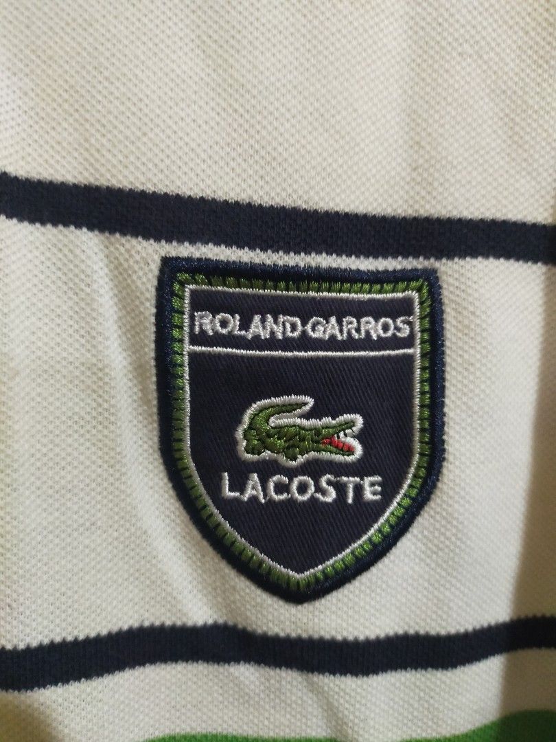 Original Lacoste (Category: Tshirts & Polo Shirts ) located in Quezon City. Submitted by leejong720610 (Listing ID 1467684497, Image 3). Description: Lacoste Roland Garros white striped polo shirt featuring a co-branded or special-edition shield patch on the chest. Lightly used. Needs to wash since naitago s balikbayan box. size 7.