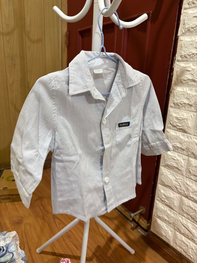 OshKosh B'Gosh Blue Striped Button-Down Shirt Size L (Category: Babies & Kids Fashion) located in Antipolo. Submitted by baneinei (Listing ID 1467758742, Image 1). Description: - Brand: OshKosh B'Gosh - Style: Long-sleeve button-down shirt - Pattern: Light blue and white stripes - Size: L (Made in the Philippines) best fit 1-3 years old - Condition: Excellent pre-loved condition - Perfect for casual outings or smart-casual looks.