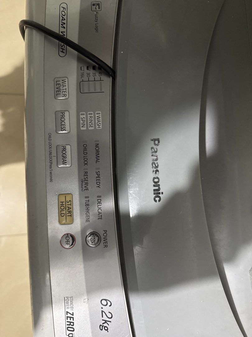 Panasonic 6.2kg Top Load Washing Machine (Category: Washing Machines and Dryers) located in Manila. Submitted by acluttering (Listing ID 1467765655, Image 1). Description: Panasonic washing machine, 6.2kg capacity. Fuzzy logic control panel with multiple wash programs including normal, speedy, delicate, and tub hygiene. Grey and white body with some surface scratches and marks from regular use. Includes attached drain hose and power cord. Works f