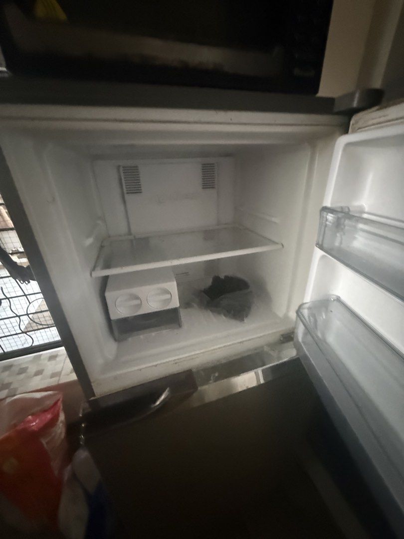 Panasonic Silver Double Door Refrigerator (Category: Refrigerators and Freezers) located in Quezon City. Submitted by thone_carlos2021 (Listing ID 1467620678, Image 2). Description: - Brand: Panasonic EcoNavi Inverter Model NR-BL268 - Type: Double door refrigerator - Color: Silver finish with cute front door magnets - Top Freezer: Includes built-in ice maker box and single shelf - Lower Section: Equipped with 2 shelves and a bottom crisper drawer