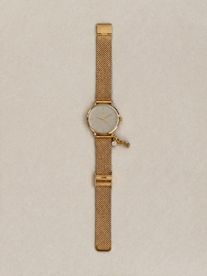 PARFOIS Gold Mesh Strap Watch with Charm (Category: Women's Watches) located in Manila. Submitted by maxinesotto (Listing ID 1467612657, Image 2). Description: Gold watch from Parfois, mesh strap style. Includes a small rhinestone charm hanging near the case. Back is stainless steel. Comes packed inside its original pink presentation box with price tag attached. Simple, clean minimalist face design in gold and white tones..