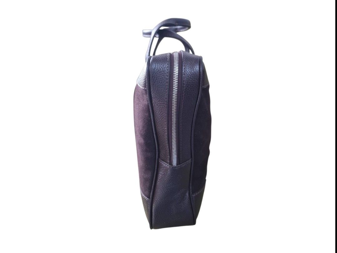 Patek Philippe Brown Leather And Canvas Briefcase (Category: Luxury Bags & Wallets) located in Paombong. Submitted by dosbagshop (Listing ID 1467616737, Image 3). Description: - Brand: Patek Philippe - Material: Brown textured leather and dark canvas fabric - Handles: Dual top handles with structured front and back straps - Closure & Interior: Main zip compartment with fabric lining and embossed leather logo patch - Protection: Four silver metal 