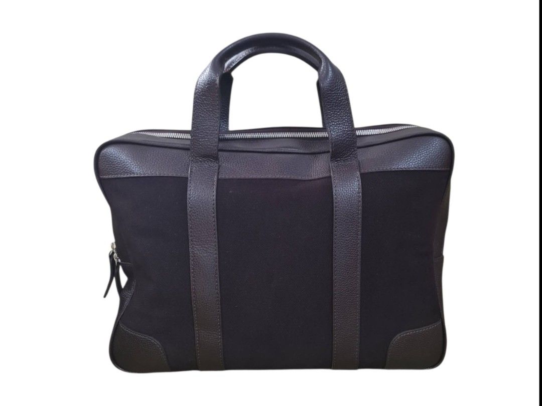 Patek Philippe Brown Leather And Canvas Briefcase (Category: Luxury Bags & Wallets) located in Paombong. Submitted by dosbagshop (Listing ID 1467616737, Image 1). Description: - Brand: Patek Philippe - Material: Brown textured leather and dark canvas fabric - Handles: Dual top handles with structured front and back straps - Closure & Interior: Main zip compartment with fabric lining and embossed leather logo patch - Protection: Four silver metal 
