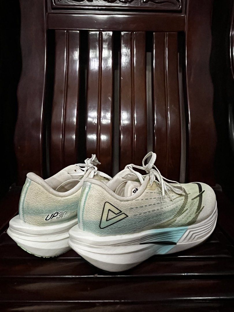 PEAK UP30 5.0 (Category: Sneakers) located in Quezon City. Submitted by mashkit (Listing ID 1467794542, Image 1). Description: - Brand: PEAK UP30 running shoes - Color: White and green gradient - Upper: Lightweight mesh with padded collar and lace-up closure - Sole: Thick cushioned sole with black and green traction pattern - Condition: Clean uppers with minimal wear on the outer soles - Best for: Daily training or race days.