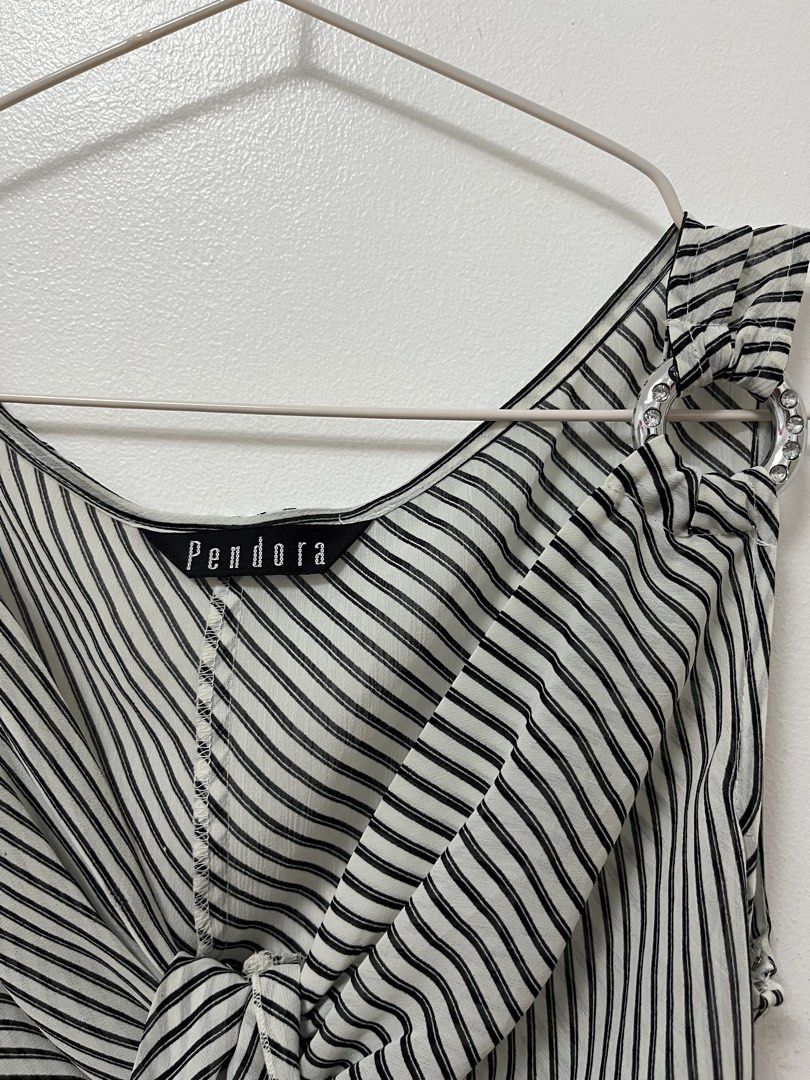 Pendora Black and White Striped Sleeveless Blouse (Category: Sleeveless) located in Batangas. Submitted by povofkbscloset (Listing ID 1467669184, Image 2). Description: - Brand: Pendora - Design: Black and white striped see through sleeveless blouse - Neckline: V-neck with trendy front - Details: Eye-catching silver rhinestone rings on both shoulder straps - Fabric: Lightweight with a mix of diagonal and vertical stripes - Versatility: Easy to pa