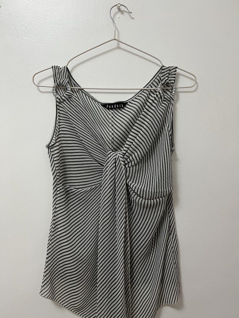 Pendora Black and White Striped Sleeveless Blouse (Category: Sleeveless) located in Batangas. Submitted by povofkbscloset (Listing ID 1467669184, Image 1). Description: - Brand: Pendora - Design: Black and white striped see through sleeveless blouse - Neckline: V-neck with trendy front - Details: Eye-catching silver rhinestone rings on both shoulder straps - Fabric: Lightweight with a mix of diagonal and vertical stripes - Versatility: Easy to pa