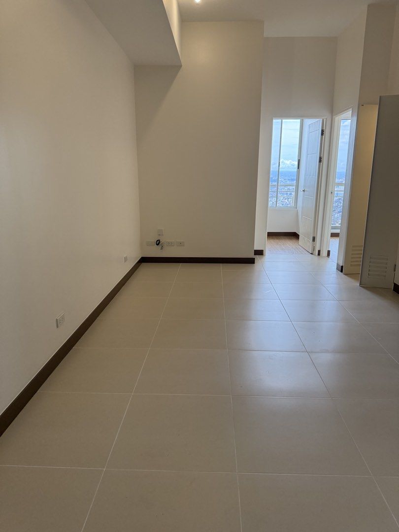 PENTHOUSE UNIT ALLEGRA GARDENS (Category: Bathroom & Kitchen Fixtures) located in Caloocan City. Submitted by angelamana15628 (Listing ID 1467787901, Image 2). Description: - High-floor condominium unit PH10, bright and ready for move-in - Living areas feature neutral tiled flooring, white walls, and dark baseboards - 2bedroom with wood-effect laminate flooring and large sliding windows - Stunning cityscape and water views from the bedroom - Tile
