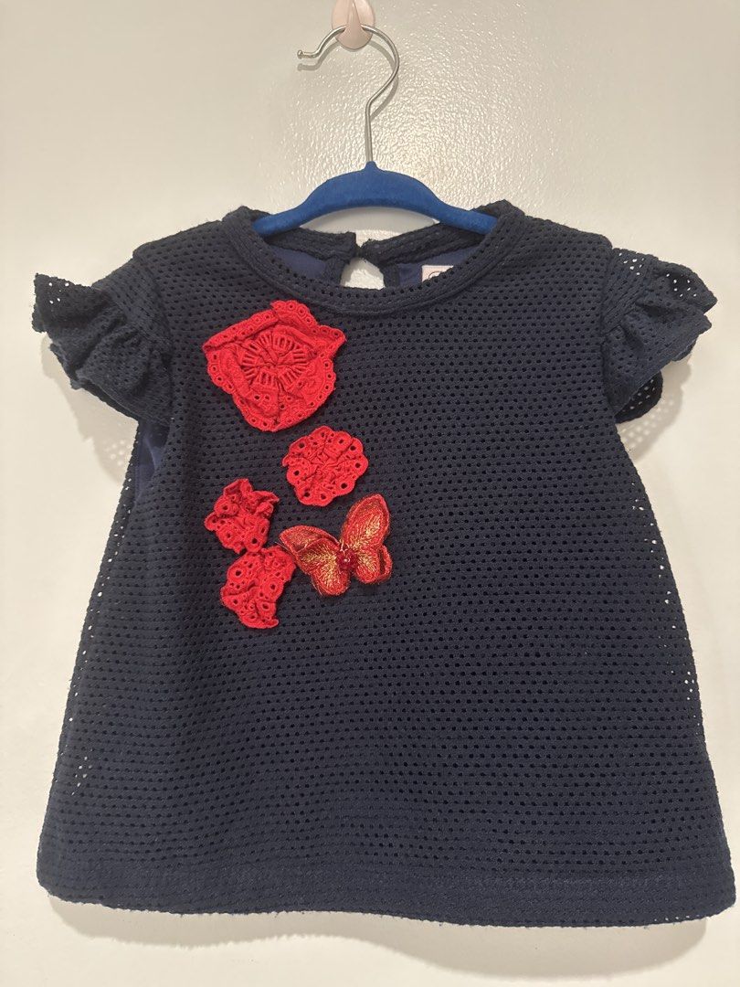 Peppermint Navy Blue Floral Applique Top Size 4 (Category: Babies & Kids Fashion) located in Manila. Submitted by hopesanddreams_closet (Listing ID 1467680220, Image 1). Description: - Brand: Peppermint - Size: Kids 4 - Color: Dark navy blue with red rosettes and gold butterfly applique - Material: Textured mesh fabric with solid blue lining - Design: Short flutter sleeves and back keyhole button closure - Condition: Worn a few times, washed, and