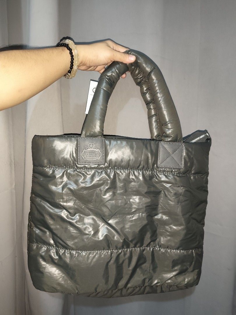 Peridot Puffer Tote Bag Grey (Category: Tote Bags) located in Rizal. Submitted by chicout (Listing ID 1467617564, Image 2). Description: - Brand: Peridot - Color: Grey with black interior lining - Condition: Brand new with original tag attached - Features: Quilted body, comfortable puffy top handles, secure top zipper closure, and an internal open pocket with a leather brand patch - Versatility: Great size for daily use, school, or work .