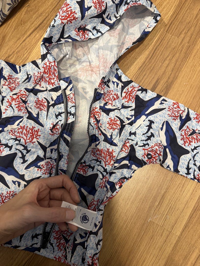 Petit Bateau Shark Print Hooded Jacket 12M (Category: Babies & Kids Fashion) located in Makati City. Submitted by rockandraw (Listing ID 1467756091, Image 1). Description: - Brand: Petit Bateau - Size: 12M / 74cm - Design: All-over shark and coral print in blue, red, and white - Features: Hooded, full front zipper closure, lightweight material - Origin: Made in India - Condition: Clean inside and out, excellent ready-to-wear condition.