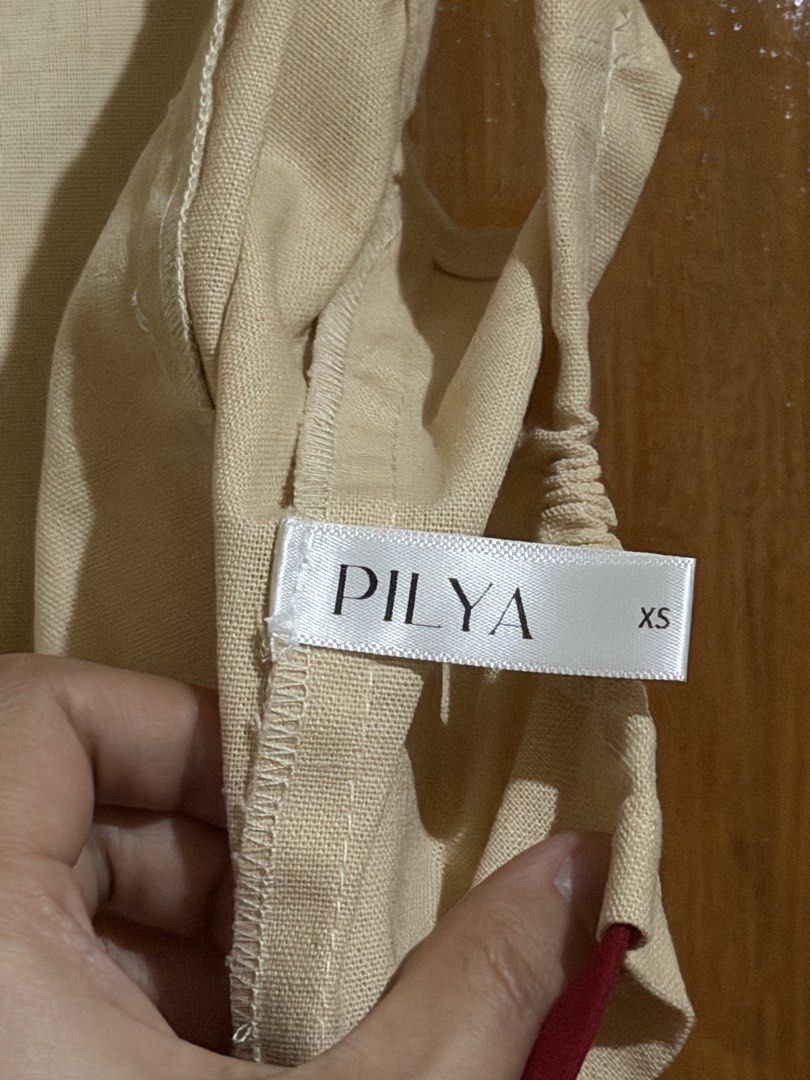 Pilya Beige Crop Top with Red Straps (Category: Sleeveless) located in Caloocan City. Submitted by sisi_p (Listing ID 1467655724, Image 3). Description: - Brand: Pilya - Size: XS - Color: Beige with deep red spaghetti straps - Design: Ruffled hem at bottom and back, open-back with tie closure.
