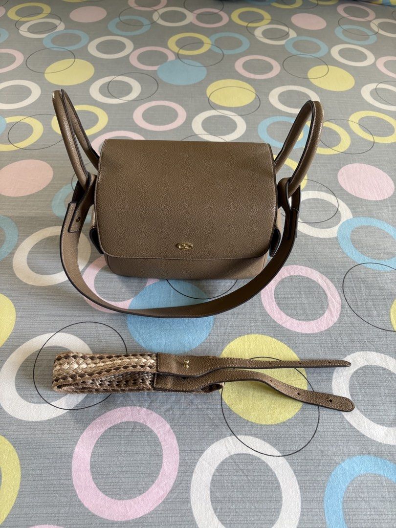 Pimmy Taupe Leather Shoulder Bag with Interchangeable Straps (Category: Shoulder Bags) located in Paranaque City. Submitted by kenzoivan20 (Listing ID 1467648679, Image 3). Description: Taupe leather shoulder bag, structured rectangular shape with a front flap closure and gold-tone hardware. Includes two straps: one solid leather strap and one patterned woven strap. Multiple small side pockets and a back slip pocket. Clean interior and exterior, 