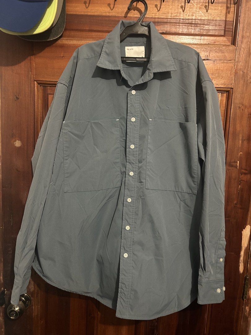 PIN SKTBS Blue Button Up Shirt Size S (Category: Tshirts & Polo Shirts ) located in Lucena. Submitted by cityboyfits (Listing ID 1467837528, Image 1). Description: - Brand/Model: PIN SKTBS Button-Up Shirt - Color: Slate Blue - Size: Small - Dimes: 29x27 - Material: 100% Cotton - Details: Long sleeves, front button closure, classic collar, two large chest pockets, clean inside tag with calendar graphic - Condition/Style: Solid basic piece, great f