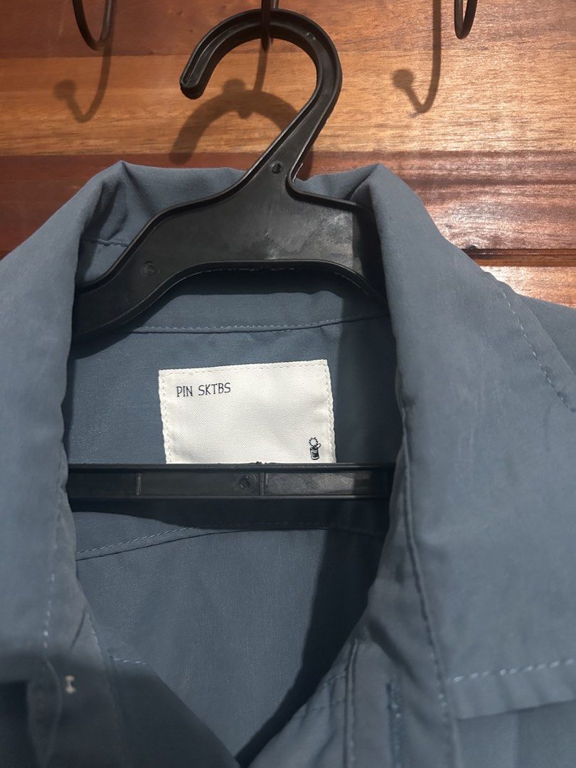 PIN SKTBS Blue Button Up Shirt Size S (Category: Tshirts & Polo Shirts ) located in Lucena. Submitted by cityboyfits (Listing ID 1467837528, Image 2). Description: - Brand/Model: PIN SKTBS Button-Up Shirt - Color: Slate Blue - Size: Small - Dimes: 29x27 - Material: 100% Cotton - Details: Long sleeves, front button closure, classic collar, two large chest pockets, clean inside tag with calendar graphic - Condition/Style: Solid basic piece, great f